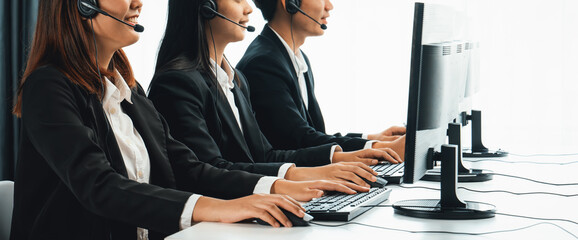 Business people wearing headset working in office to support remote customer or colleague. Call...