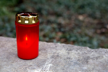 Red candle at a grave