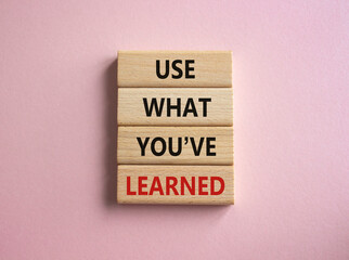 Use what You have learned symbol. Wooden blocks with words Use what You have learned. Beautiful pink background. Business and Use what You have learned concept. Copy space.