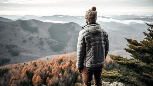 A hiker enjoys a stunning view of the mountains while wearing Merino wool layers.