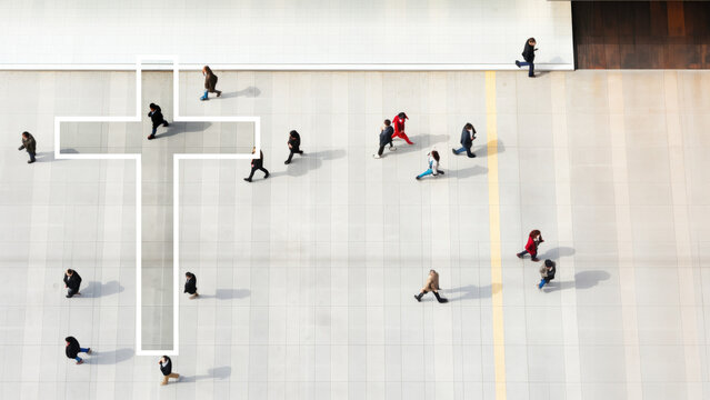Cross on an aerial view of a crowd of people walking. Conceptual with copy space