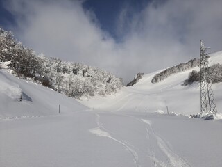 Skiing turns traces on fresh snow. Winter landscape.
