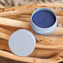 blue jar with blue eye patches on wooden background