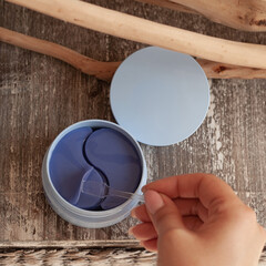 blue jar with blue eye patches on wooden background