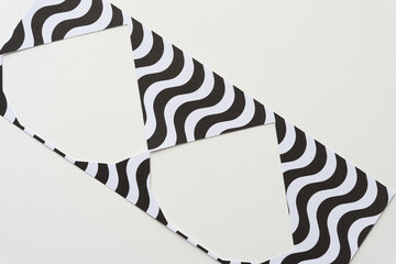 machine-cut stencil with wavy lines and triangle forms on blank paper