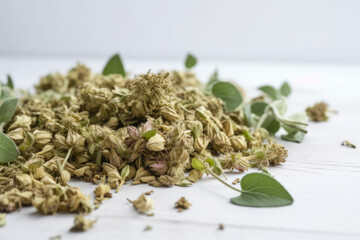 Dried Oregano spice on a white wooden background side view