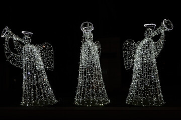 Three illuminated Christmas angels at the Christmas market