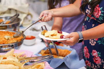 hand delicately savoring food, representing the joy and sensory pleasure of culinary indulgence
