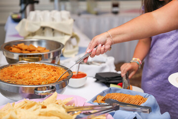 hand delicately savoring food, representing the joy and sensory pleasure of culinary indulgence