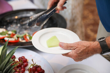 hand delicately savoring food, representing the joy and sensory pleasure of culinary indulgence