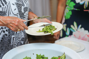 hand delicately savoring food, representing the joy and sensory pleasure of culinary indulgence