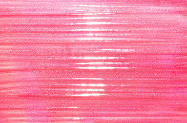 Pink shimmering lip gloss texture background with highlights. Smudged cosmetic product smear. Makup swatch product sample - obrazy, fototapety, plakaty