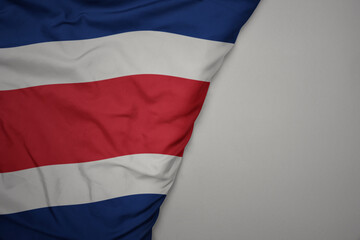 big waving national colorful flag of costa rica on the gray background.