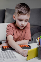 Child calculates an arithmetic problem orally. Mental arithmetic. Portrait of a boy doing...