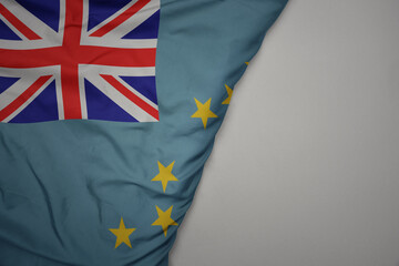 big waving national colorful flag of Tuvalu on the gray background.