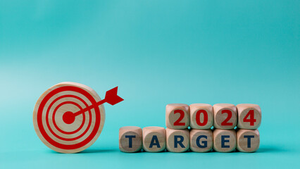 Business target and dartboard with the word Target 2024 on blue background. 2024 target concept.