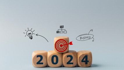 2024 goals of business or life. Wooden cubes with 2024 and goal icon on smart background. Starting...