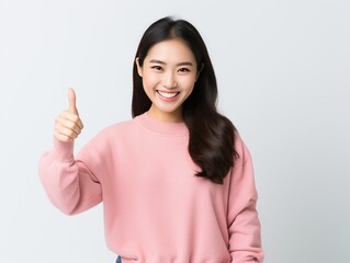 Smilling asian woman showing thumb up 