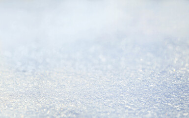 Winter christmas background - view of the snowdrift sparkling in the rays of the winter sun, selective focus