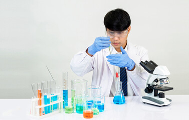 Portrait asian man student scientist Wearing a doctor gown in the lab looking hand at chemist....