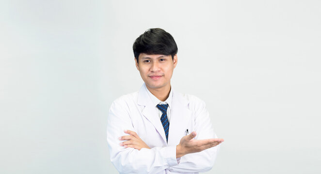 Portrait young man asian student scientist or doctor one person, wearing white gown, standing, looking and smiling stethoscope auscultating the heart around his neck. in lab room white background