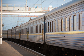 A long-distance passenger train made a stop in a small town, photographed in clear weather in...