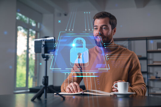 Happy man is making video blog using smartphone on a tripod explaining, teaching, master class people in room. Concept of online stream, business education, conference call. Lock Security info seminar