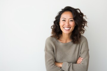 Obraz premium Lifestyle portrait photography of a Vietnamese woman in her 30s wearing a cozy sweater against a white background