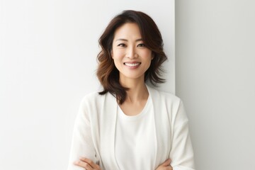 Lifestyle portrait photography of a Vietnamese woman in her 30s against a white background