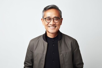 Fototapeta premium Medium shot portrait photography of a Vietnamese man in his 50s against a white background