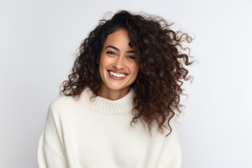 Fototapeta premium Medium shot portrait photography of a Peruvian woman in her 30s wearing a cozy sweater against a white background
