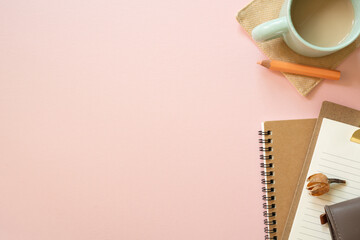 Notebook, clipboard, pouch, colored pencil, cup of coffee, dry flower on pink desk background. flat...