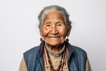 Portrait photography of a 100-year-old elderly Peruvian woman wearing a denim jacket against a white background