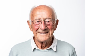 Portrait photography of a French man in his 80s wearing a simple tunic against a white background