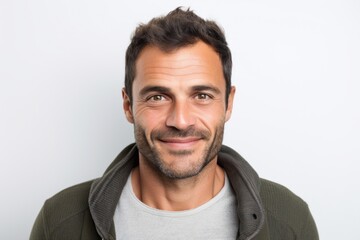 Portrait photography of a serious Colombian man in his 30s against a white background