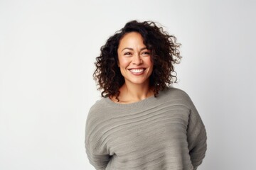 Fototapeta premium Medium shot portrait photography of a Colombian woman in her 40s wearing a cozy sweater against a white background
