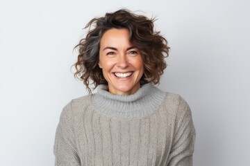 Medium shot portrait photography of a Italian woman in her 40s wearing a cozy sweater against a white background