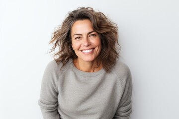 Medium shot portrait photography of a Italian woman in her 40s wearing a cozy sweater against a white background