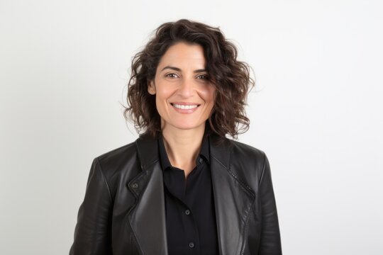 Portrait photography of a Italian woman in her 40s wearing a classic blazer against a white background