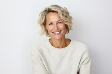 Portrait photography of a Swedish woman in her 40s wearing a cozy sweater against a white background