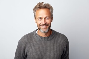 Fototapeta premium Medium shot portrait photography of a Swedish man in his 40s wearing a cozy sweater against a white background