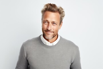 Medium shot portrait photography of a Swedish man in his 40s wearing a cozy sweater against a white background