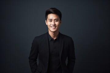 Fototapeta premium Medium shot portrait photography of a Vietnamese man in his 20s against a minimalist or empty room background