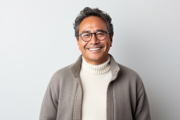 Obraz premium Lifestyle portrait photography of a Peruvian man in his 50s against a minimalist or empty room background