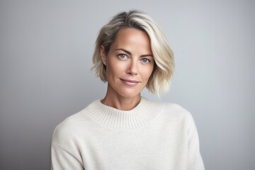 Fototapeta premium Medium shot portrait photography of a Swedish woman in her 40s wearing a cozy sweater against a minimalist or empty room background