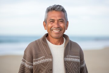 Portrait photography of a Peruvian man in his 50s against a beach background