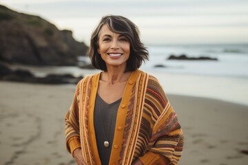 Group portrait photography of a Peruvian woman in her 60s against a beach background