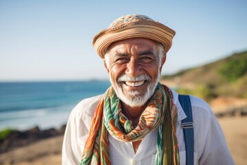 Fototapeta premium Lifestyle portrait photography of a Colombian man in his 60s wearing a foulard against a beach background