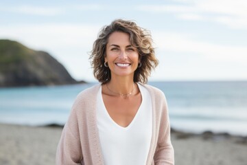 Medium shot portrait photography of a Italian woman in her 40s against a beach background