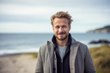 Portrait photography of a Swedish man in his 30s against a beach background